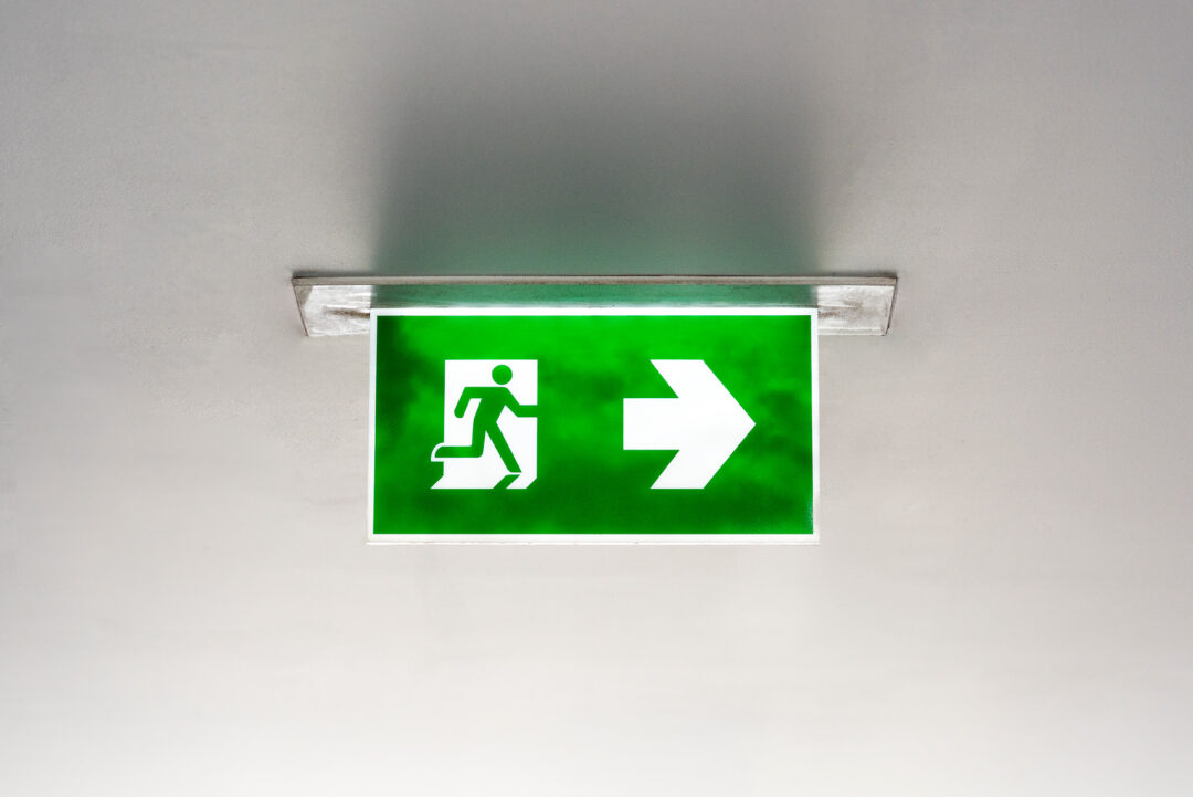 green exit sign on ceiling